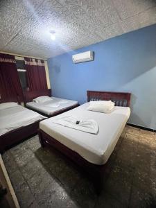 Ένα ή περισσότερα κρεβάτια σε δωμάτιο στο hotel dorado