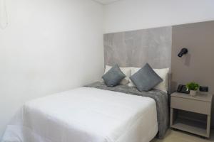 Postel nebo postele na pokoji v ubytování ApartaHotel Estadio