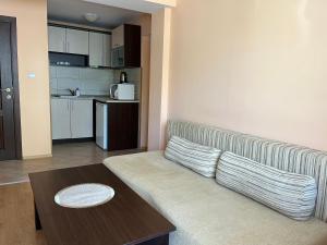 a living room with a couch and a table at Hotel Silver in Sozopol
