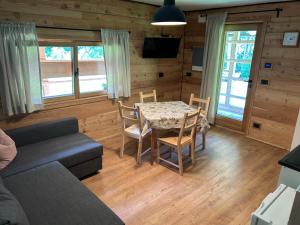 a living room with a table and a couch at Lärchenwirt Dolomites in San Niccolò Comèlico