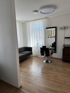 a living room with a couch and a chair at Barbers Corner in Talsi