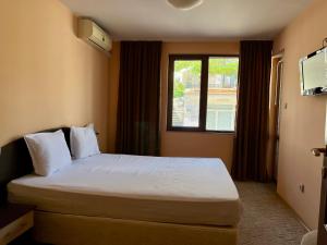 a hotel room with a bed and a window at Hotel Silver in Sozopol +37 photos