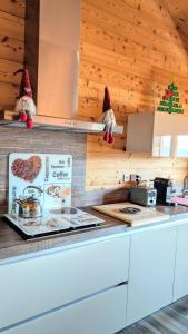 a kitchen with a counter with santa hats on the counter at Chalet Cosy avec vue imprenable sur le lac in La Celle-sous-Gouzon +17 photos