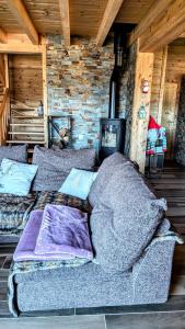 a large bed in a room with a brick wall at Chalet Cosy avec vue imprenable sur le lac in La Celle-sous-Gouzon