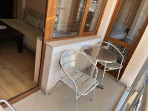 a balcony with a table and chairs in a room at Hotel Silver in Sozopol