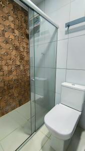 a bathroom with a toilet and a glass shower at Pousada HAI in Fernando de Noronha +23 photos