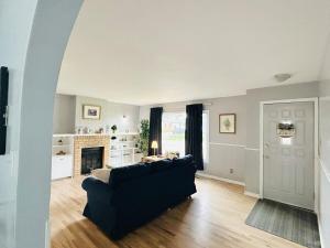 a living room with a couch and a fireplace at Fully Furnished, Contractor-friendly,4Beds, Free Parking&Laundry, Corporate Housing in Thompson