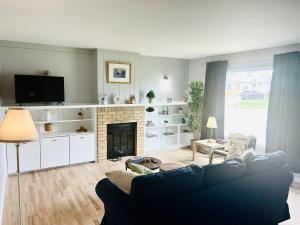 a living room with a couch and a fireplace at Fully Furnished, Contractor-friendly,4Beds, Free Parking&Laundry, Corporate Housing in Thompson