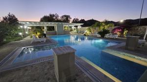 a large swimming pool in a backyard at night at Residence l'oasi in San Lorenzo