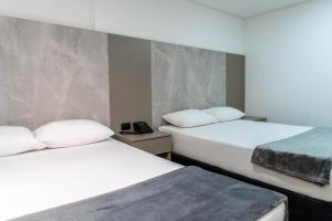 Postel nebo postele na pokoji v ubytování ApartaHotel Estadio