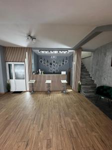 an empty room with a staircase and a large room with wooden floors at Vila Amalia Munții Macinului in Măcin