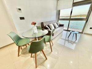 a living room with a couch and a table and chairs at El capricho de la Ría I in O Grove