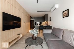 a living room with a couch and a table at PLATiNiUM RESiDENCE GARDEN SASKI - "CENTRUM" in Lublin
