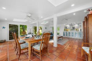 a kitchen and dining room with a table and chairs at Alaeloa 35 in Kapalua +58 photos