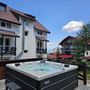 a hot tub on the balcony of a building at Vila Alpin in Straja