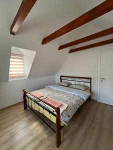 a bedroom with a bed in a room with wooden floors at Lipovo Mountain House in Kolašin