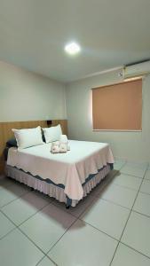 a bedroom with a bed with towels on it at Pousada HAI in Fernando de Noronha