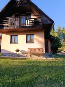 a house with a bench in front of it at Chata Carla in Žiar