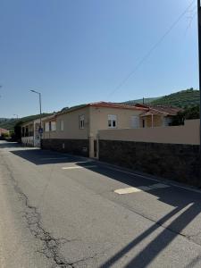 an empty street in front of a building at Casa Carvalho in Peso da Régua