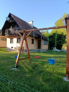a swing set in the yard of a house at Chata Carla in Žiar