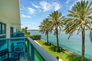 a view of the water from the balcony of a house at Beach Haus Bal Harbour in Miami Beach