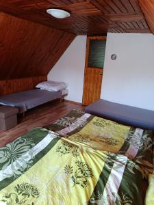 a bedroom with a bed and a bench in a room at Chata Carla in Žiar