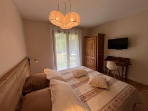 a bedroom with a bed with pillows and a window at Gîtes du Grand Replomb in Sainte-Agnès