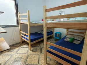a room with two bunk beds and a window at Casa Maria Flor Guest House in Itacaré