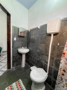 a bathroom with a toilet and a sink at Casa Maria Flor Guest House in Itacaré +12 photos