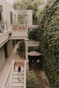 a woman walking down the stairs of a building at Casa Seis Siete in Mexico City