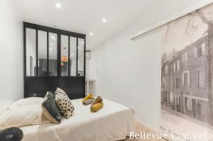 a bedroom with a bed with pillows on it at Les Bellevue Cité Trivalle, Cité 500m, free private car park on demand, free public car park 200m, aircon, WIFI, Cité view terrace in Carcassonne