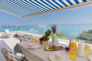 a table with food on it with a view of the ocean at Morska vila Sanja in Starigrad-Paklenica