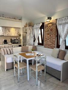 a room with a bed and a table and a couch at Villa Kaldera Skiathos in Skiathos