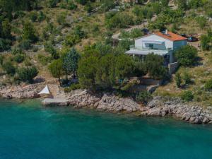a house on a hill next to a river at Morska vila Sanja in Starigrad-Paklenica