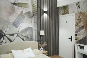a living room with a couch and a wall mural at TROPICAL ROOMS Vista Mare in Cirò Marina