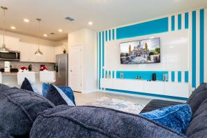 a living room with blue and white striped walls at Luxury 5 Bed Townhome with Private Pool - Solterra - 7598 OS in Davenport