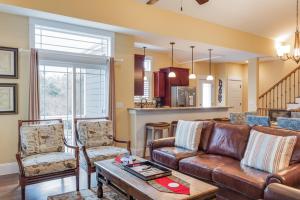 a living room with a brown leather couch and chairs at Seaside Serenity in Corolla