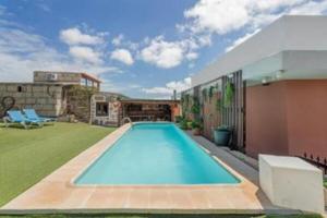 a swimming pool in the backyard of a house at F tamaide in San Miguel de Abona