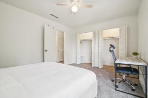 a white bedroom with a bed and a desk at The Trails K256 I Spacious And Comfy 1 Bed 1 Bath in Gainesville +15 photos