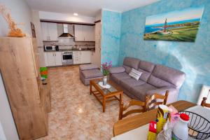 a living room with a couch and a table at Muxia Mare in Muxia