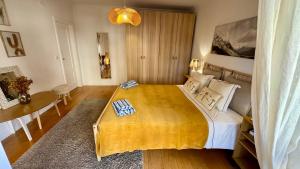 a bedroom with a large bed and a table at Oceanfront 2 bedrooms apartment with swimming pool & garage in Cascais