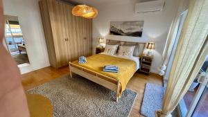 a bedroom with a bed and a table in it at 2 bedrooms with swimming pool Nomad Dreams N 7 in Cascais