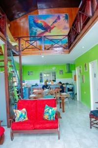 a red couch in a room with a painting on the ceiling at TJ Comfort Villa Suriname in Paramaribo