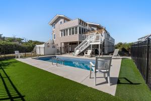a house with a swimming pool in the yard at Serenity Shores in Southern Shores