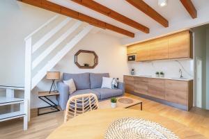 a living room with a couch and a table at Modern loft with ocean views in Villajoyosa