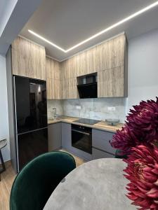 a kitchen with a table and a counter top at Xenia luxury apartment in Katerini