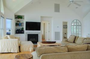 a living room with two couches and a fireplace at Links End in Nags Head