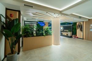 a lobby with a large aquarium with plants in it at Hotel Dorna in Vatra Dornei +158 photos