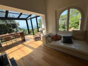 a living room with a couch and a large window at Villa Denise in Bidart