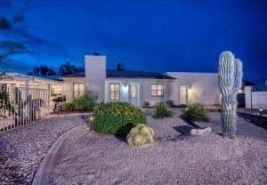 a house with a cactus in the front yard at Your Private Desert Getaway With Free Heated Pool! in Phoenix